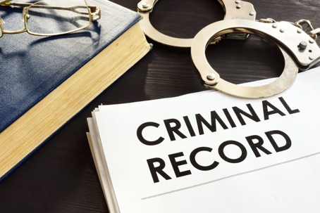 Criminal record and hand cuffs
