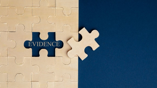 Paper puzzles on a blue background. Selective focus.